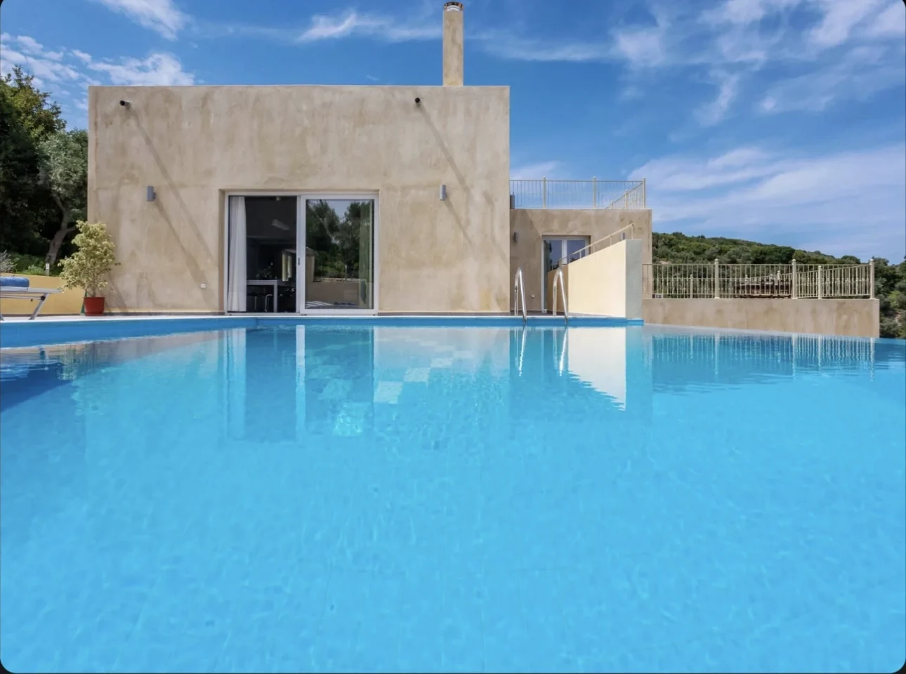Outdoor pool area with sun loungers and panoramic sea views